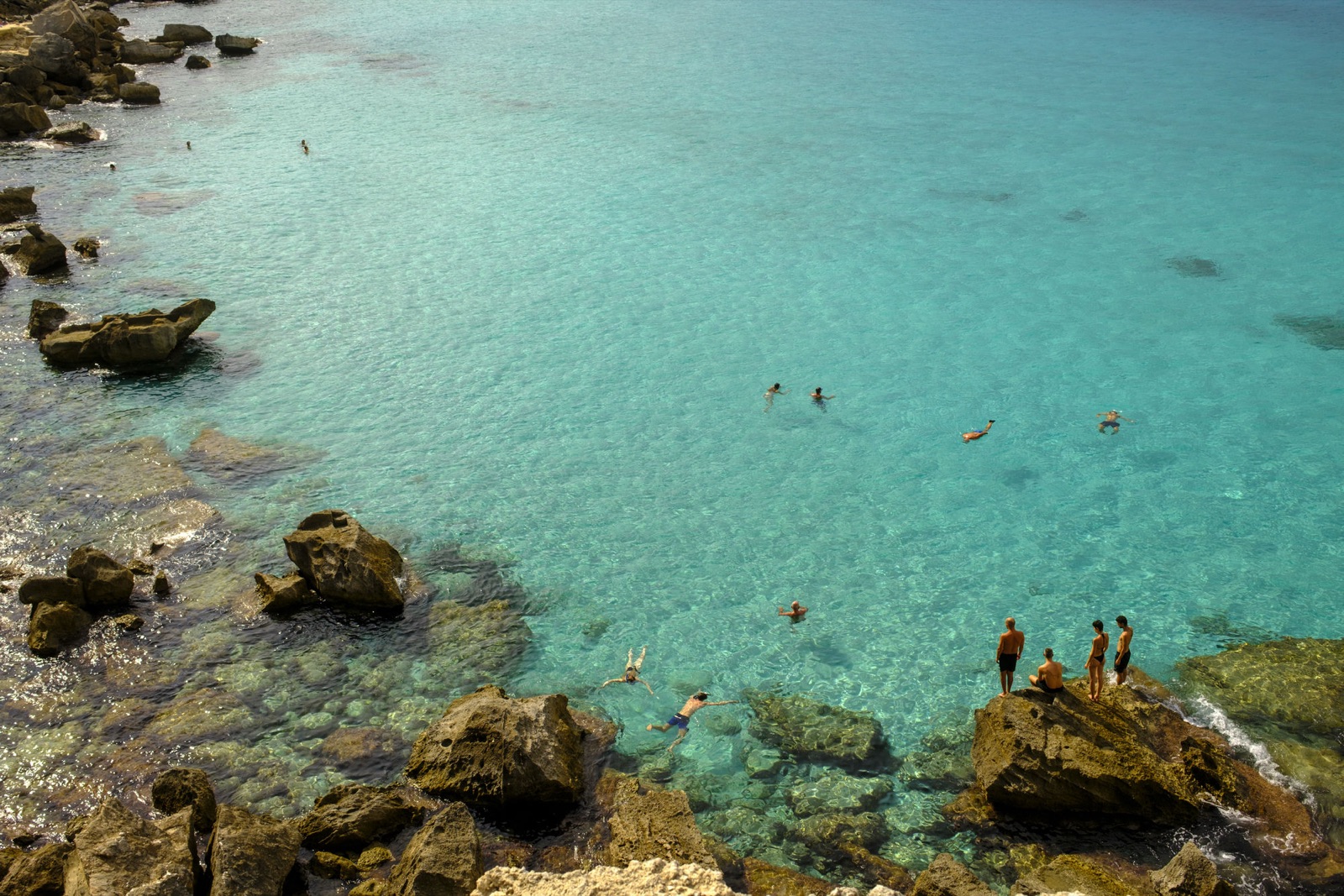 Swimmers in a clearwater cove